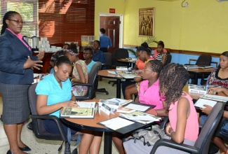 Director, Public Service Capability Development, Management Institute for National Development (MIND), Ann-Marie Smith (left), addresses participants in the FEMPower Leadership Programme, during the opening ceremony for the course today (July 15), at the MIND Kingston campus. 