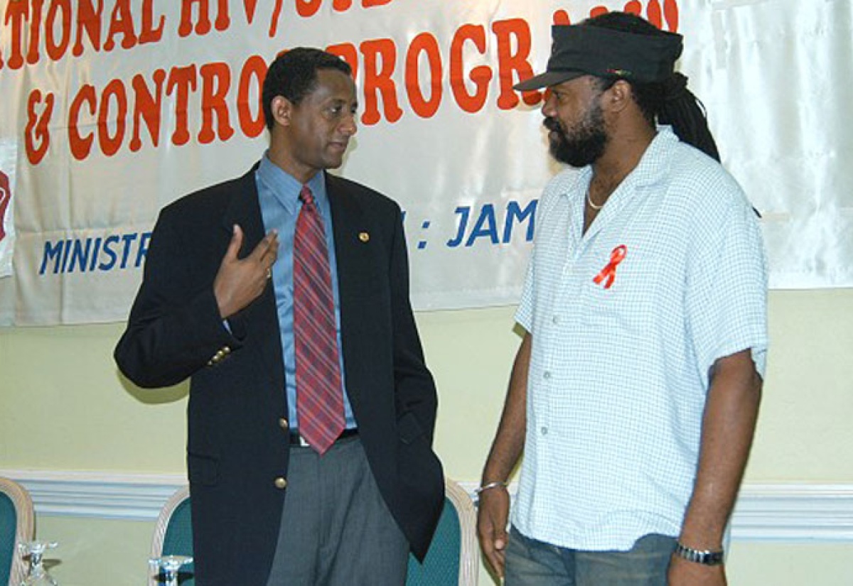 Dr. Yitades Gebre (left), Senior Medical Officer and Executive Director of Jamaica HIV/AIDS Prevention and Control Project (left), in discussion with entertainer and Chairperson of Artistes Against AIDS, Tony Rebel, at a World AIDS Week Conference at the Knutsford Court Hotel in Kingston in 2004.