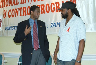 Dr. Yitades Gebre (left), Senior Medical Officer and Executive Director of Jamaica HIV/AIDS Prevention and Control Project (left), in discussion with entertainer and Chairperson of Artistes Against AIDS, Tony Rebel, at a World AIDS Week Conference at the Knutsford Court Hotel in Kingston in 2004.