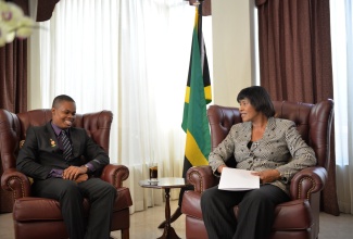 Time with the PM: Prime Minister Portia Simpson Miller raps with Global Youth Ambassador for the Caribbean and Latin America Shaquille Ramsay Wednesday (February 17), during a courtesy call at the Office of the Prime Minister, 1 Devon Road.  Mr. Ramsay was accompanied by a delegation of youth ambassadors as well as representatives of the Ministry of Youth and Culture.   The Global Youth Ambassador discussed with the Prime Minister matters concerning his mandate and the Global Volunteer Network which appointed him. Mrs. Simpson Miller congratulated him on being the first Jamaican to be appointed to the position and expressed confidence that he will do well.
