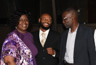 Permanent Secretary in the Ministry of Culture, Gender, Entertainment and Sport, Denzil Thorpe (right) share in a conversation with (from left): Director of the United Kingdom (UK)-based company, One Step Forward Consultancy, Patricia McKenzie- Thomas and Welterweight Champion of Jamaica, Sakima Mullings during the second day of the fourth annual International Safeguarding Children’s Conference held from May 17 to18 at the Jamaica Conference Centre, Downtown, Kingston.