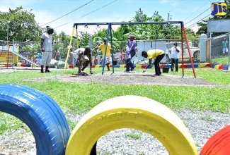 Volunteers  pave the play area at the St. Ann’s Bay Infant School in St. Ann, which was one of the national  projects for Labour Day on May 23.