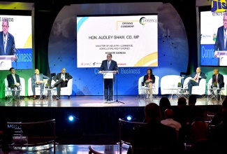 Minister of Industry, Commerce, Agriculture and Fisheries, Hon. Audley Shaw (standing), delivers the main address at the opening ceremony of the Jamaica Investment Forum (JIF) 2018, at the Iberostar Rose Hall Suites hotel, on June 12. Listening keenly (from left) are Chief Development Officer, New Fortress Energy, Brannen McElmurray; President and CEO, Scotia Group Jamaica, David Noel; Chairman and Director General, Planning Institute of Jamaica, Dr. Wayne Henry; President, Jamaica Promotions Corporation (JAMPRO), Dianne Edwards; Chairman of JAMPRO, Senator Don Wehby; and Regional Director, Business Year Magazine, Han Lee. 