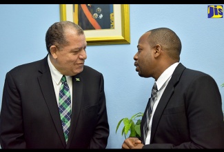 Minister of Industry, Commerce, Agriculture and Fisheries, Hon. Audley Shaw (left), speaks with Project Manager, Strategic Public Sector Transformation Project, Ministry of Finance and the Public Service, Othneil Hemans, after the launch of the ISO Quality Systems Implementation Technicians (Q-SITs/Junior Consultants) Training Course, at the Management Institute for National Development (MIND) in St. Andrew on Monday (June 18).

