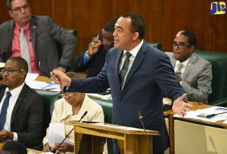 Minister of Health, Dr. the Hon. Christopher Tufton, making his contribution to the 2018/19 Sectoral Debate in the House of Representatives on June 5. At left is State Minister in the Ministry of Education, Youth and Information, Hon. Floyd Green; and Minister without Portfolio in the Ministry of Finance and the Public Service, Hon. Fayval Williams.

