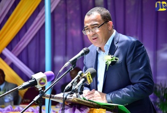 Minister of Health, Dr. the Hon. Christopher Tufton, addresses the renaming ceremony of Bog Walk High School to the Enid Bennett High School, in Bog Walk, St. Catherine, on Tuesday (June 19).

