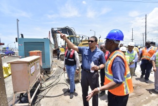 Prime Minister, the Most Hon. Andrew Holness (left, foreground), makes a point to Chief Executive Officer, National Works Agency, E.G. Hunter, about a matter concerning improvement works being done on Hagley Park Road in St. Andrew, during a tour of the project on Friday (June 1). Hagley Park Road Improvement Project was among several legacy projects, being developed in the Corporate Area under the Major Infrastructure Development Programme, which Mr. Holness toured.