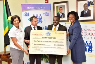 Director of the Phillip and Christina Gore Family Foundation, Christine Gore (left), and National Coordinator for the HOPE Programme, Colonel Martin Rickman (second left), display a cheque for $6 million that was handed over to the programme, today (June 25), in Kingston.  Also holding cheque are Chairman, Board of Directors, HEART Trust/ NTA, Edward Gabbidon, and Managing Director of the HEART Trust/NTA, Dr. Janet Dyer. The Gore Family Foundation recently formed a partnership with the HEART Trust/ NTA in support of unattached youth in St. James and St. Catherine. The money will be used to pay the stipend of 50 participants in the HOPE Programme. They will be working as interns with Gore Developments Limited. 