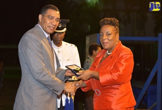 Prime Minister, the Most Hon. Andrew Holness, presents Principal of St. Aloysius Primary School in Kingston, Althea Palmer, with the 2018 Prime Minister’s Medal of Appreciation for Service to Education. Ms. Palmer is one of 40 educators who were recognised this year. The presentations were made during Wednesday’s (June 27) awards ceremony at Jamaica House.