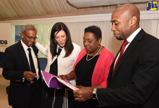 Women’s health 1: Minister of Culture, Gender, Entertainment and Sport, Hon. Olivia Grange (2nd right), looks through a copy of the Jamaica Women’s Health Survey Report following the launch at the Terra Nova All Suite Hotel on June 21. Others from left are:  Senior Director for the Social Policy, Planning and Research Division, Planning Institute of Jamaica,  Easton Williams; Regional Director, Americas and the Caribbean, United Nations Women, Luiza Carvalho; and Chief Technical Director, Ministry of National Security, Rohan Richards. 