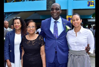 Minister of Education, Youth and Information, Senator the Hon. Ruel Reid (centre), is flanked by relatives of the late Enid Bennett (from left): niece, Bridget Orrett; sister, Gloria Martin; and grand-niece, Belinda Orrett. Occcasion was a ceremony to officially rename the Bog Walk High School in St. Catherine, the Enid Bennett High School, held on June 19 on the school grounds.
 
