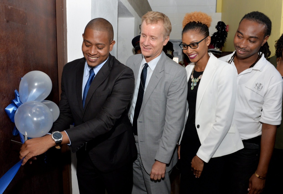 Minister of State in the Ministry of Education, Youth and Information, Hon. Floyd Green (left), cuts the ribbon to symbolize the official opening of a homework centre and a music recording studio which have been established at the newly rebranded St. Catherine Youth Innovation Centre (YIC). Also participating (from second left), are: Acting Mission Director, United States Agency for International Development (USAID), Andrew Colburn; Senior Director, Youth and Adolescent Policy Division, Education, Youth and Information Ministry, Naketa West; and Youth Empowerment Officer, Gihon Mitchell. The opening took place during a ceremony at the centre’s Young Street location on June 7.