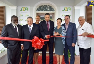 Prime Minister, the Most Hon. Andrew Holness (centre), officially opens the Jamaica Special Economic Zone Authority (JSEZA) head office on Waterloo Road, St. Andrew, on Wednesday (July 11). Sharing the occasion (from left) are JSEZA Chief Executive Officer, Dr. Eric Deans, and Chairman, Metry Seaga; Minister without Portfolio in the Ministry of Finance and the Public Service, Hon. Fayval Williams; Foreign Affairs and Foreign Trade Minister, Senator the Hon. Kamina Johnson Smith; and Ministers without Portfolio in the Ministry of Economic Growth and Job Creation, Hon. Daryl Vaz, and Hon. Mike Henry.