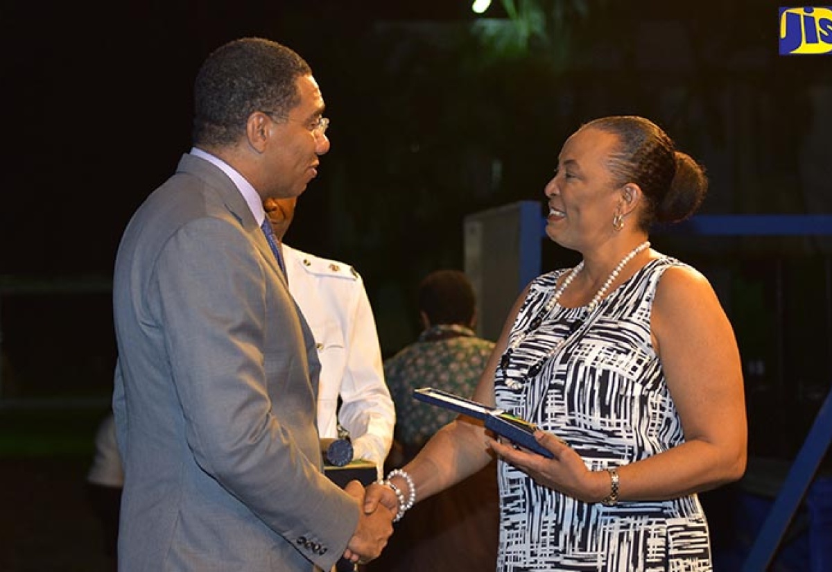 Prime Minister, the Most Hon. Andrew Holness, presents former Director of the Education System Transformation Programme (ESTP) in the Ministry of Education, Youth and Information, Jean Hastings,with the Prime Minister’s Medal of Appreciation for Service to Education at the awards ceremony held in June at Jamaica House.