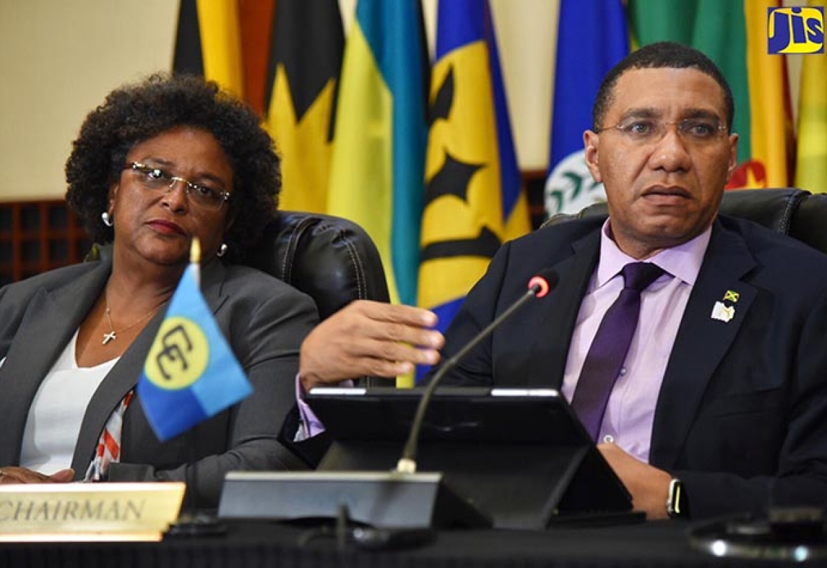 Prime Minister, the Most Hon Andrew Holness (right), responds to questions from journalists during a press conference on Friday (July 6), following the 39th Regular Meeting of the Conference of Heads of Government of the Caribbean Community (CARICOM), which was held at the Montego Bay Convention Centre in St. James from July 4 to 6.  Also pictured is Prime Minister of Barbados, Hon. Mia Mottley. 