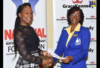 Top student for the National Child Month Committee’s (NCMC) 2018 Youth Academic Achievement Awards, Britney Huie (left), receives her award from NCMC Chairperson, Dr. Pauline Mullings, during the presentation ceremony at Knutsford Court Hotel, New Kingston on June 27. 