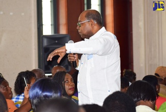 Tourism Minister, Hon. Edmund Bartlett, addressing members of the craft sector during a recent meeting at the Montego Bay Convention Centre in Rose Hall, St. James. 