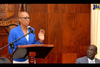 Minister without Portfolio in the Ministry of Finance and the Public Service, Hon. Fayval Williams, addressing journalists during Wednesday’s (July 25) Post Cabinet Press Briefing at Jamaica House. Looking on is Education, Youth and Information Minister, Senator the Hon. Ruel Reid.