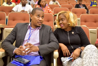 State Minister for Education, Youth and Information, Hon. Floyd Green (left), in discussion with Chief Executive Officer (CEO) and Founder of Youth for Sustainable Development (Y4SD), Rochelle Reid James, prior to the start of a two-day Y4SD conference at the University of Technology (UTech), in St. Andrew, on Thursday (July 26).