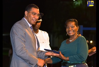 Prime Minister, the Most Hon. Andrew Holness, presents former Vice principal of the May Pen Primary School, Mrs. Isoline A. Brown-Budhoo, with the 2018 Prime Minister’s Medal of Appreciation for Service to Education at the awards ceremony held on June 27 at Jamaica House.