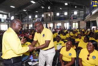 Minister of Education, Youth and Information, Senator the Hon. Ruel Reid (left), greets newly elected President of the National Parent-Teacher Association of Jamaica (NPTAJ), Lennon Richards, at the Association’s Sixth Biennial General Meeting and National Conference, held at Jamaica College in St. Andrew on July 14.