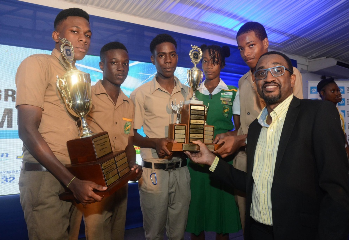 PCJ Winners: Petroleum Corporation of Jamaica (JCJ) Special Projects Manager, Peter Ruddock (right), presents the winning trophy in the 2017/18 PCJ Schools Energy Programme Competitionton to students of Winston Jones High School in Manchester. The are (from left) Ruchshane Williamson, Okelo Smith, Shawn Clarke, Kadine Jordine and Christopher Morgan. The awards ceremony was held recently at the Spanish Court Hotel in New Kingston.