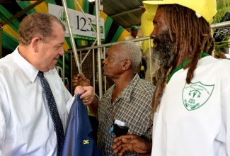 Industry, Commerce, Agriculture and Fisheries Minister, Hon. Audley Shaw (left), engages in discussion with farmers, Eric Young (centre) and Sherlon Michael, at the 123rd annual general meeting (AGM) of the Jamaica Agricultural Society (JAS), held at the Denbigh showground in May Pen, Clarendon, on July 11. 