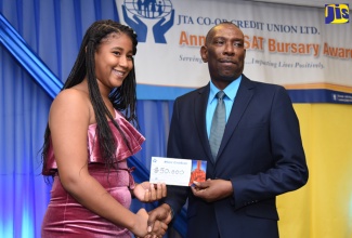 General Manager of the Jamaica Teachers’ Association (JTA) Co-operative Credit Union, Robert Ramsay (right), presents a cheque for $50,000 to Lorell Duncan. Occasion was the credit union's 2018 Grade Six Achievement Test (GSAT) awards function held on July 27 at the Knutsford Court Hotel in New Kingston. 