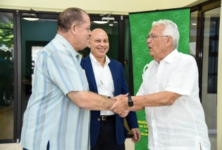 Industry, Commerce, Agriculture and Fisheries Minister, Hon. Audley Shaw (left), greets Chairman, Jamaica Producers Group Limited (JPG), Charles Johnston (right), on arrival at the company’s Fourth Avenue, Newport West facility in Kingston on Friday (August 24). Looking on is JPG Chief Executive Officer, Jeffery Hall.