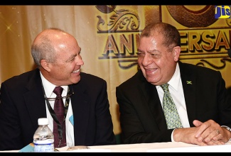 Industry, Commerce, Agriculture and Fisheries Minister, Hon. Audley Shaw (right), converses with Inter-American Accreditation Cooperation (IAAC) Chairman, Randy Dougherty,  during Monday’s (August 27) opening ceremony for the IAAC’s 23rd Annual General Assembly at the Hilton Rose Hall Resort and Spa in Montego Bay, St. James.