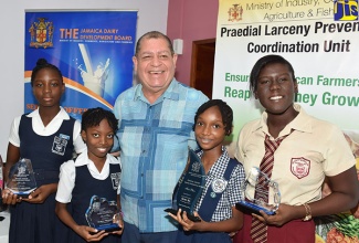 Minister of  Industry, Commerce, Agriculture and Fisheries, Hon. Audley Shaw,  with participants  in the Praedial Larceny Prevention Unit essay and poster competition, at the awards ceremony, held today (August 28) at the Ministry,  Hope Gardens. At second left is winner in the poster category, Sehu Ray. Others (from left) are Camara Hamilton (second, essay competition);  Alaine Preston (second, poster competition) and Angelique Forrest (third, poster competition). 