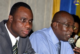 Education, Youth and Information Minister, Senator the Hon. Ruel Reid (right), addressing parents during a question and answer session at the Ministry’s parent sensitisation session for Region’s One and Two, at the Karram Speid Auditorium, Merl Grove High School, Kingston, on August 16. Also pictured is Permanent Secretary in the Ministry, Dean-Roy Bernard.