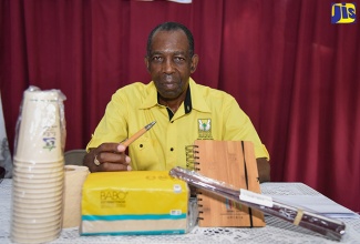 Minister without Portfolio in the Ministry of Industry, Commerce, Agriculture and Fisheries, Hon. J.C. Hutchinson, holds a pen made from bamboo at the Rural Agricultural Development Authority (RADA) Agricultural Development Stakeholders Forum held on August 21 at the Richmond Gap Church of God of Prophecy, St. Thomas. 