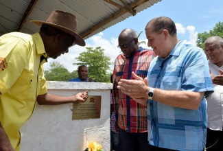 Industry, Commerce, Agriculture and Fisheries Minister, Hon. Audley Shaw (right), applauds following the unveiling of a plaque at one of the livestock barns at the Denbigh showground in May Pen, Clarendon, which was renamed in honour of late renowned veterinarian, Dr. Thomas Phillip Lecky, during the 66th Denbigh Agricultural, Industrial and Food Show on August 4. Others (from left) are: outgoing Jamaica Agricultural Society (JAS) President, Norman Grant; Opposition Spokesperson on Agriculture, Dr. Fenton Ferguson; and JAS President-elect, Lenworth Fulton. The 66th Denbigh Agricultural, Industrial and Food Show is being held from August 4 to 6 under the theme: ‘Grow What We Eat, Eat What We Grow: Agriculture, Securing Our Future’.