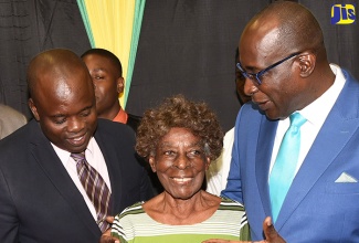 Minister of Education, Youth and Information, Senator the Hon. Ruel Reid (right) shares in conversation with Retired School Teacher, Grace Lawrence, at the Grace Scholarship Fund reception held at the University of the West Indies, Regional Headquarters in Kingston on September 1. At left is Senior Pastor, Ewarton Gospel Lighthouse Church, Dr. Dean Reid. The Grace Scholarship Fund offers financial assistance for students who are continuing their tertiary education.

