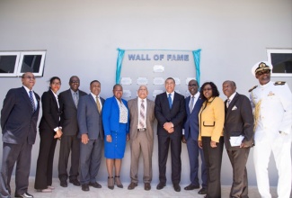 Prime Minister Andrew Holness stands by the Wall of Fame at the FESTO FACT Centre at Caribbean Maritime University along with other persons who were instrumental in the establishment of the centre. (Left to right) Dr Wesley Hughes, Shakierah Cowan, Dr Alwyn Hayles, Phillip Paulwell, Dr Grace McLean, Dr Omar Davies, Senator Ruel Reid, Mrs Audrey Sewell, Rev. Wellesley Blair & Professor Fritz Pinnock. 