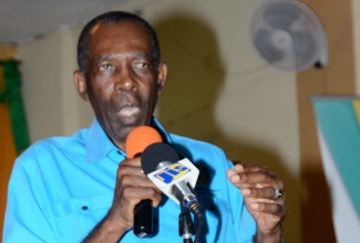 Minister without Portfolio in the Ministry of Industry, Commerce, Agriculture, and Fisheries, Hon. JC Hutchinson addresses stakeholders during the launch of the Jamaica Constabulary Force Farmers Watch group, at the Dutch Hill New Testament Church of God in Ulster Spring, Trelawny on August 30.  