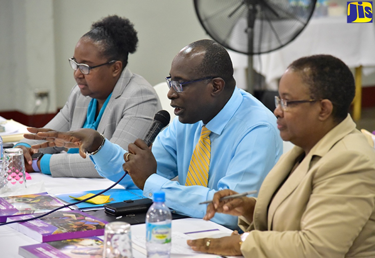 Minister of Education, Youth and Information, Senator the Hon. Ruel Reid (centre), fields questions from educators at a regional teachers’ consultation held on Tuesday (September 18) at the Port Antonio High School in Portland. He is flanked by Chief Education Officer, Dr. Grace McLean (left); and Assistant Chief Education Officer, Winnie Berry.