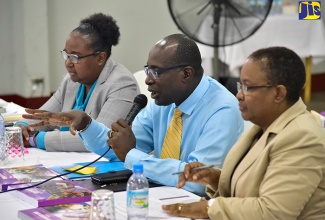 Minister of Education, Youth and Information, Senator the Hon. Ruel Reid (centre), fields questions from educators at a regional teachers’ consultation held on Tuesday (September 18) at the Port Antonio High School in Portland. He is flanked by Chief Education Officer, Dr. Grace McLean (left); and Assistant Chief Education Officer, Winnie Berry.