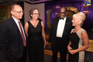 Acting Permanent Secretary in the Ministry of Industry, Commerce, Agriculture and Fisheries, Andrene Collings (second left), shares in light conversation with (from left) National Standards Council Chairman, James Rawle; Bureau of Standards Jamaica (BSJ) Executive Director,  Stephen Wedderburn; and Chief Executive Officer of American energy firm, INTREN, Kelly Tomblin, at the BSJ's National Quality Awards Ceremony and Banquet, at The Jamaica Pegasus hotel, New Kingston, on Tuesday (October 16). 