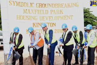 Prime Minister, the Most Hon. Andrew Holness (third left), breaks ground for the $860-million Maxfield Park Development Project during a ceremony at the project site along Ricketts Crescent on Wednesday (October 3).  Also participating (from left) are Deputy Mayor of Kingston, Councillor Winston Ennis; Leader of the Opposition, and Member of Parliament for St. Andrew East Central, Dr. Peter Phillips; Minister without Portfolio in the Ministry of Economic Growth and Job Creation, Hon. Karl Samuda; Chairman, National Housing Trust (NHT), Lennox Channer; and Managing Director, NHT, Donald Moore.