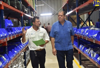 Minister of Industry, Commerce, Agriculture and Fisheries,  Hon. Audley Shaw (right), tours Isratech’s retail outlet with Vice President of Sales and Marketing,  Benjamin Hodara, prior to the official opening of the company’s new complex in Reading, St James, on Wednesday (October 10).