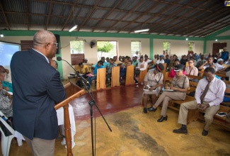 Project Manager for the implementation of the US$2.5-billion Vernamfield development project, Colonel Oscar Derby, addresses a Vernamfield Development Town Hall Meeting, held at the Power of Faith Ministries, Gimme-me-Bit, Clarendon, on Thursday (October 11).