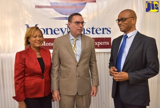 Minister without Portfolio in the Ministry of Economic Growth and Job Creation, Hon, Daryl Vaz (centre), converses with MoneyMasters Limited (MM) Director, Dennis Hickey (right), during the entity’s ‘Conversation with the Analysts’ breakfast forum, held at Eden Gardens Wellness and Spa Resort in St. Andrew on Tuesday (October 30). Mr. Vaz was the keynote speaker. The forum was held under the theme ‘Opportunities for Local Financing of Jamaica’s Infrastructure Development’.  At left is MML President, Claudette Crooks.