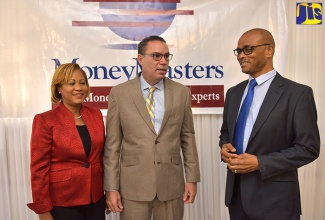 Minister without Portfolio in the Ministry of Economic Growth and Job Creation, Hon. Daryl Vaz (centre), converses with MoneyMasters Limited (MML) Director, Dennis Hickey (right), during the entity’s ‘Conversation with the Analysts’ breakfast forum, held at Eden Gardens Wellness and Spa Resort in St. Andrew on Tuesday (October 30). Mr. Vaz was the keynote speaker. The forum was held under the theme ‘Opportunities for Local Financing of Jamaica’s Infrastructure Development’. At left is MML President, Claudette Crooks.