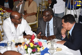 Tourism Minister, Hon. Edmund Bartlett (left), converses with Custos Rotulorum for St. James, Bishop the Hon. Conrad Pitkin (centre), and Mayor of Montego Bay and Chairman of the St. James Municipal Corporation, Councillor Homer Davis, during the Montego Bay Chamber of Commerce and Industry’s Invest MoBay Breakfast Forum, held at the Sea Gardens Beach Resort Friday (October 19)