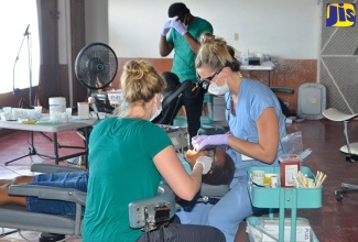 Great Shape! Inc.’s 1000 Smiles volunteers perform dental procedures during a free clinic at the Eltham community centre in Ocho Rios, St. Ann.