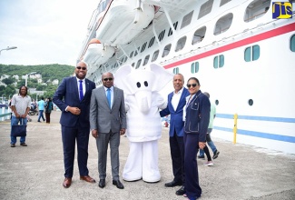 Minister of Tourism, Hon. Edmund Bartlett (second left); Chief Strategist, Delano Seiveright (left); Chief Executive Officer of the Port Authority of Jamaica, Professor Gordon Shirley (second right); and Chairperson of Jamaica Vacations, Joy Roberts, with the official mascot of the Carnival Horizon, which arrived at the Ocho Rios Cruise Pier in St. Ann  on October 2.  