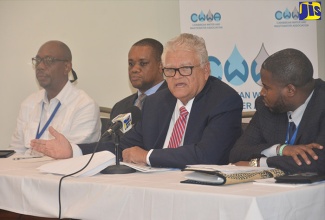 Minister without Portfolio in the Ministry of Economic Growth and Job Creation with responsibility for Water, Housing and Infrastructure, Hon. Karl Samuda (second right), addresses journalists at the Caribbean Water and Wastewater Association (CWWA) 27th Annual Conference press briefing, which was held at the Jewel Grande Montego Bay Resort and Spa in St. James on Wednesday (October 10).  With the Minister are (from left) Senior Water and Sanitation Specialist at the Inter-American Development Bank in Trinidad and Tobago, Evan Cayetano;  Division Chief, Economic Infrastructure Division at the Caribbean Development Bank in Barbados, L. O’Reilly Lewis; and  Executive Chairman at the Water and Sewerage Corporation in The Bahamas, Adrian Gibson. 