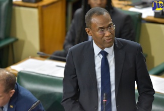 Minister of Finance and the Public Service, Dr. the Hon. Nigel Clarke,  opens debate on the First Supplementary Estimates for the 2018/19 financial year, in the House of Representatives on October 2.  At left is Minister of Industry, Commerce, Agriculture and Fisheries, Hon. Audley Shaw.